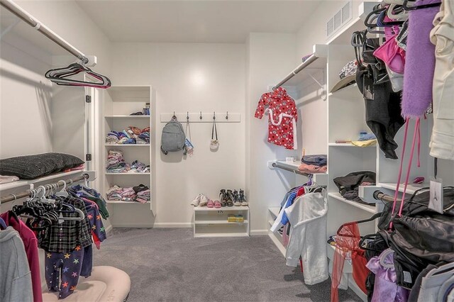 walk in closet featuring carpet and visible vents