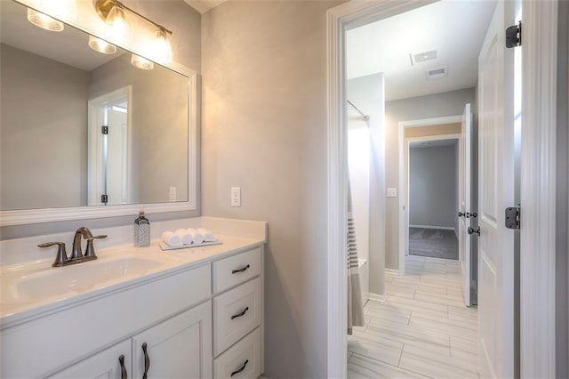 full bath featuring visible vents, a shower, and vanity