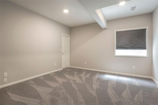 unfurnished room with carpet, visible vents, baseboards, and recessed lighting