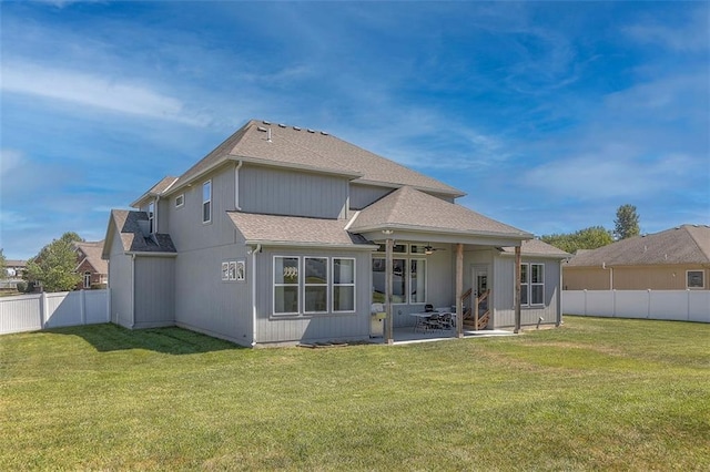 back of property featuring a yard, a patio, a fenced backyard, and a ceiling fan