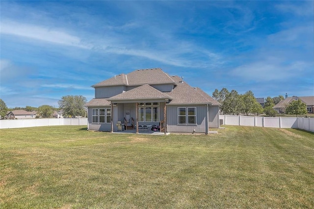 back of property featuring a fenced backyard, a yard, and a patio