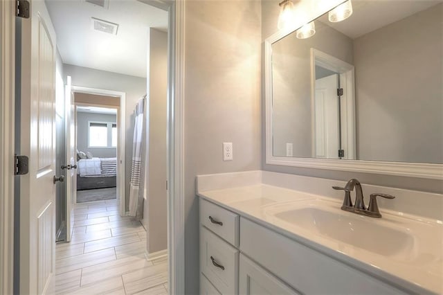 bathroom featuring visible vents, vanity, and a shower with shower curtain