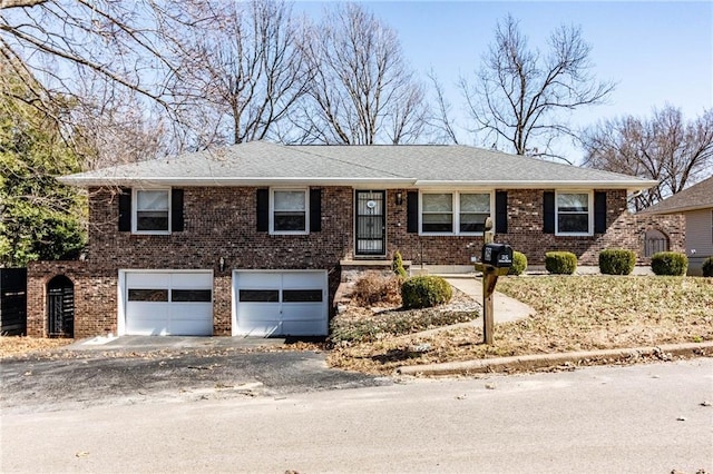 view of front of property with driveway, a shingled roof, a garage, and brick siding