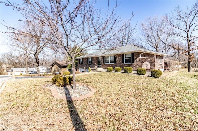 ranch-style home with a front lawn and brick siding