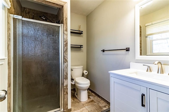 full bath featuring a shower stall, vanity, and toilet