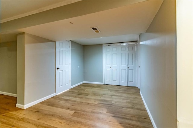 interior space with baseboards, visible vents, and light wood-style floors