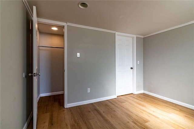 unfurnished bedroom with baseboards and wood finished floors