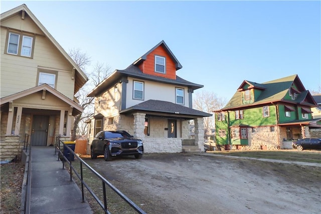 view of front of home with stone siding and driveway