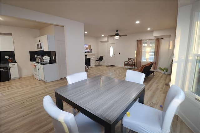 dining area featuring light wood-style floors, recessed lighting, and baseboards