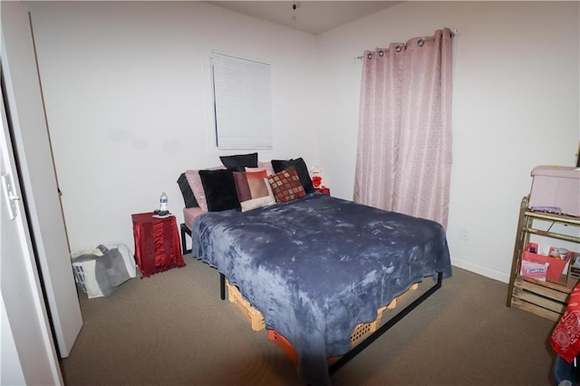 carpeted bedroom featuring baseboards