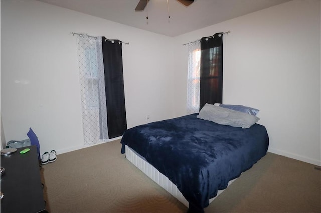 bedroom featuring carpet, baseboards, and a ceiling fan