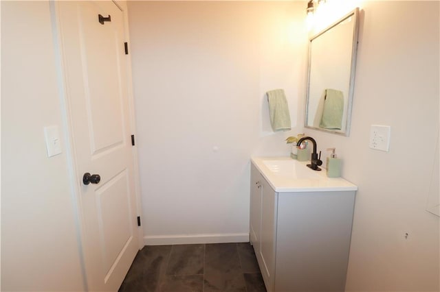 bathroom with vanity and baseboards