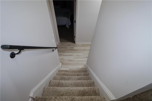 staircase featuring wood finished floors