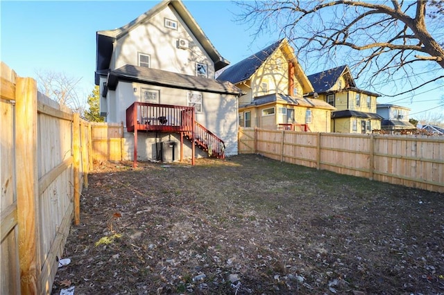 rear view of house with a fenced backyard