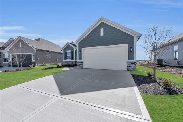 ranch-style house with stone siding, an attached garage, concrete driveway, and a front yard