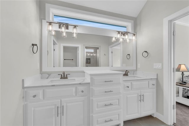 bathroom featuring double vanity, plenty of natural light, and a sink