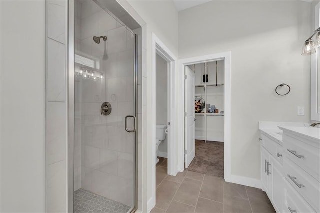 full bathroom featuring toilet, a stall shower, and vanity