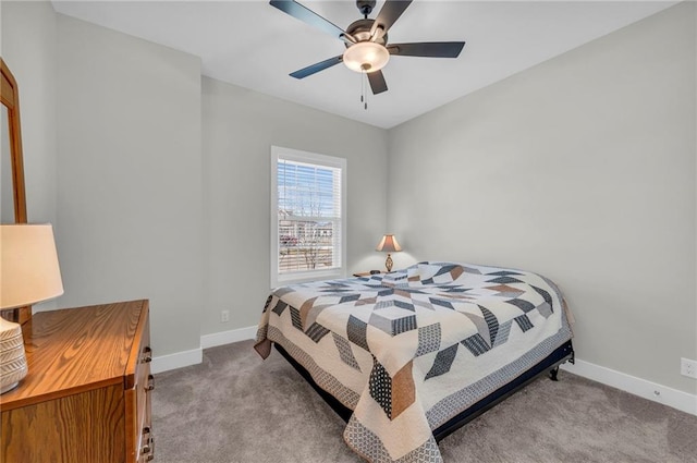 carpeted bedroom featuring a ceiling fan and baseboards