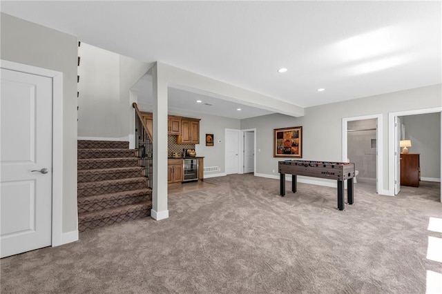 recreation room featuring recessed lighting, light colored carpet, baseboards, and bar