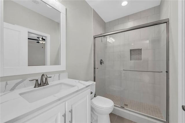 full bathroom with vanity, toilet, visible vents, and a stall shower