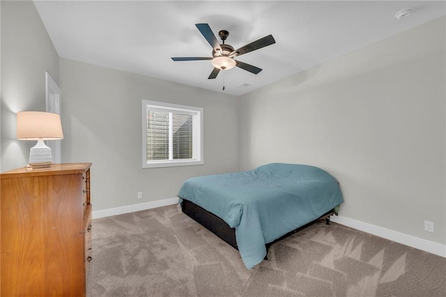 carpeted bedroom featuring baseboards and ceiling fan