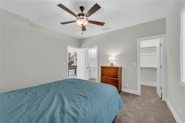 bedroom with visible vents, a ceiling fan, carpet flooring, baseboards, and a spacious closet