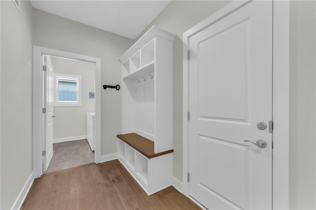 mudroom with washer / clothes dryer, baseboards, and wood finished floors