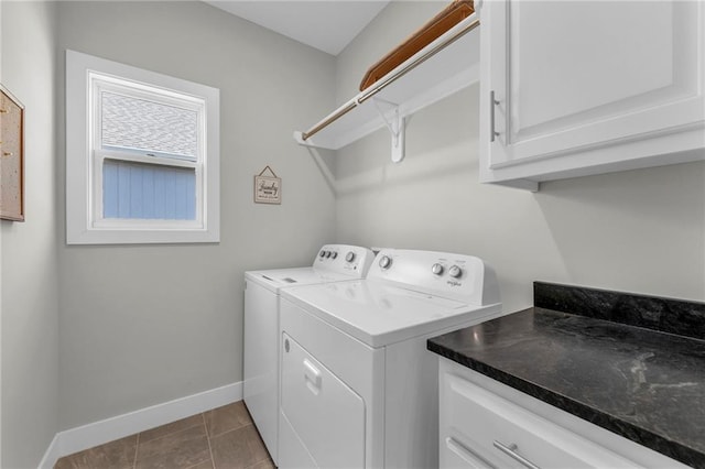 laundry area featuring cabinet space, washing machine and dryer, tile patterned floors, and baseboards