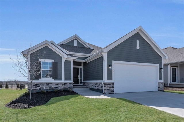 ranch-style house featuring fence, a front yard, driveway, stone siding, and an attached garage