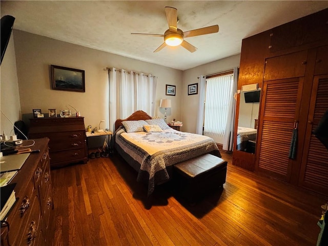 bedroom featuring dark wood-style floors and ceiling fan