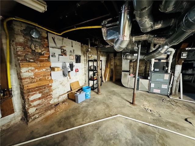 unfinished basement featuring heating unit