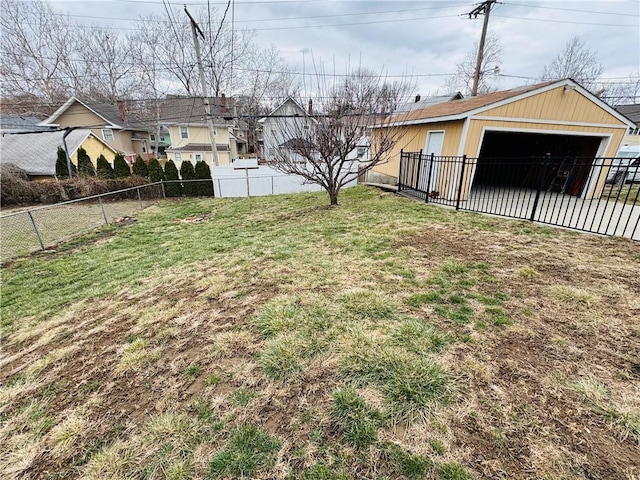 view of yard featuring a garage, an outdoor structure, and fence