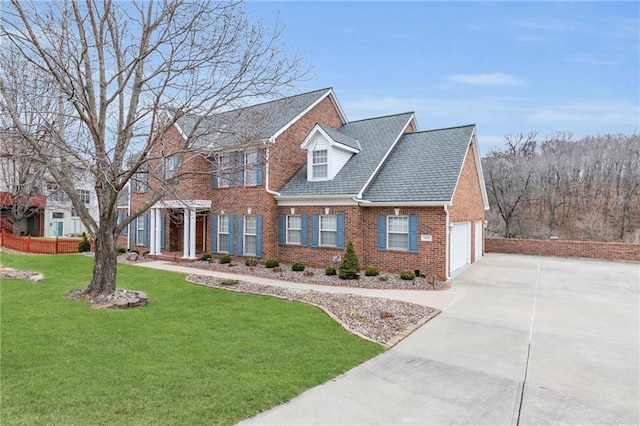 view of front of home with brick siding, driveway, and a front lawn