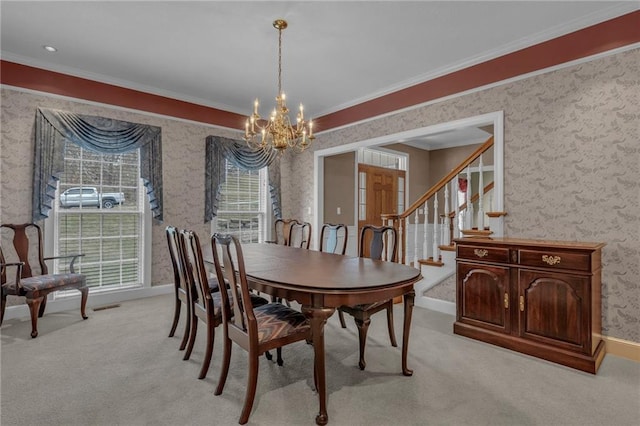 dining room featuring light carpet, stairway, crown molding, wallpapered walls, and a chandelier