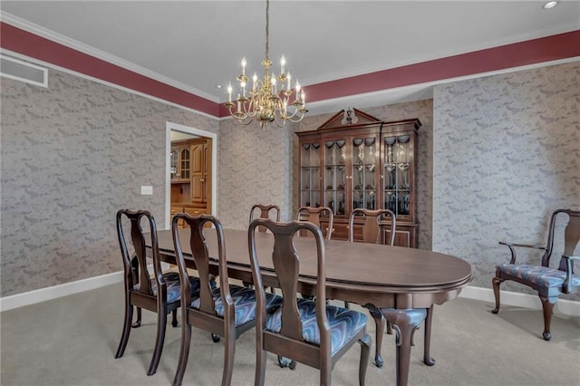 carpeted dining area featuring visible vents, baseboards, ornamental molding, and wallpapered walls