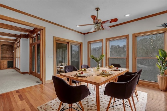 dining space with recessed lighting, light wood-type flooring, baseboards, and crown molding