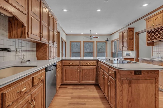 kitchen with a sink, black electric cooktop, light wood-type flooring, and dishwasher