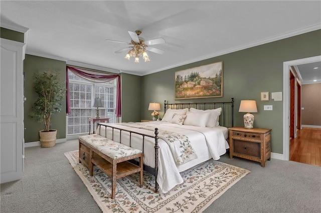 bedroom featuring ceiling fan, baseboards, ornamental molding, and carpet flooring