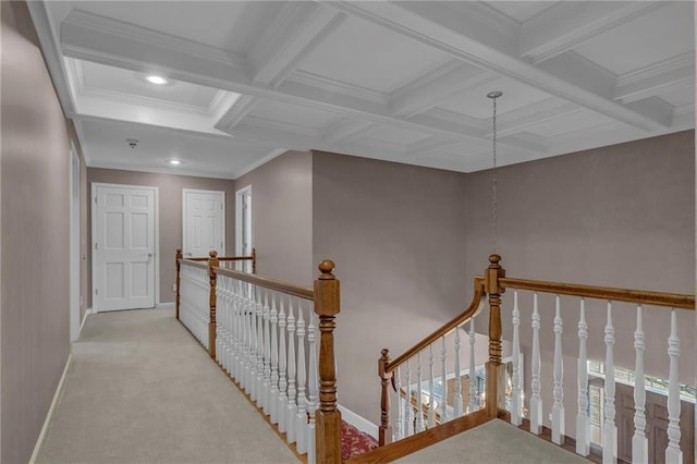 corridor featuring an upstairs landing, coffered ceiling, beam ceiling, and carpet