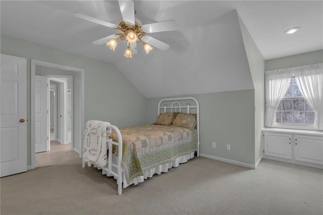 carpeted bedroom with vaulted ceiling, baseboards, and ceiling fan