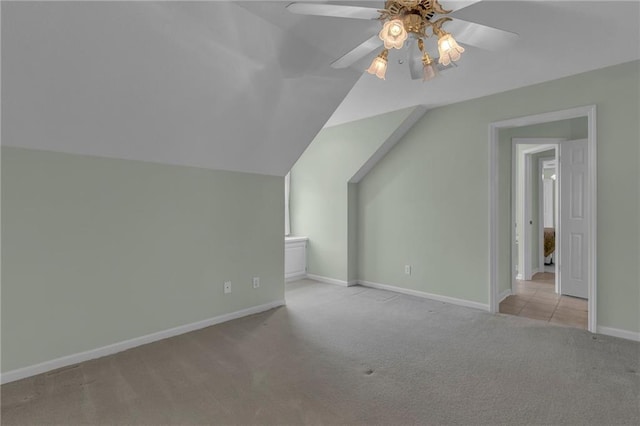 bonus room featuring baseboards, lofted ceiling, ceiling fan, and carpet flooring