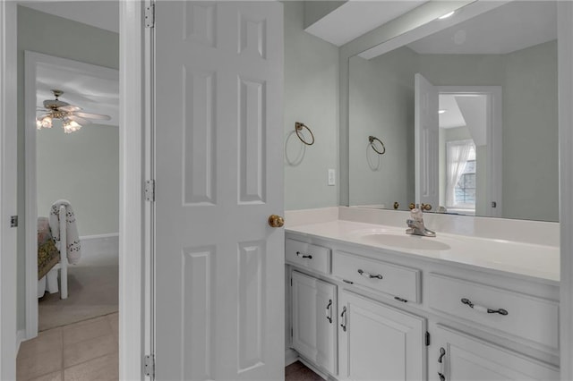 bathroom with tile patterned flooring, baseboards, vanity, and a ceiling fan