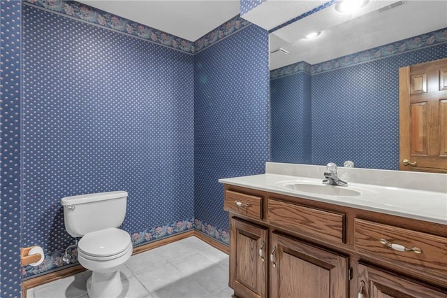 bathroom with tile patterned flooring, visible vents, wallpapered walls, toilet, and vanity