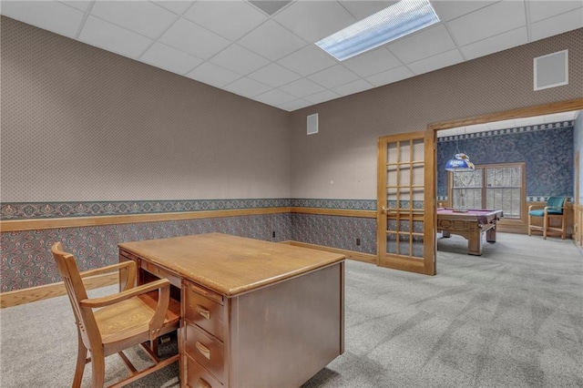 office with wallpapered walls, carpet, and a paneled ceiling