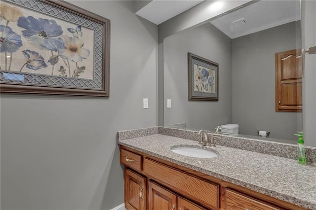 half bathroom with toilet and vanity