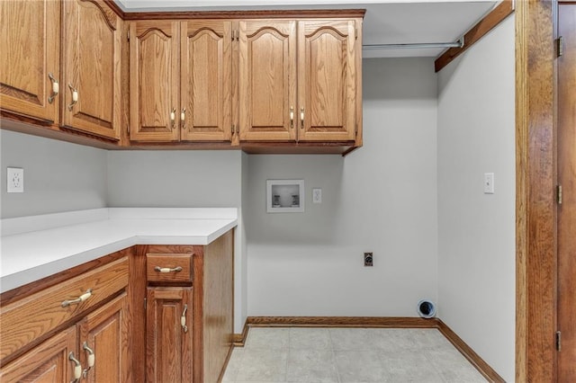 laundry area featuring baseboards, cabinet space, hookup for an electric dryer, and hookup for a washing machine