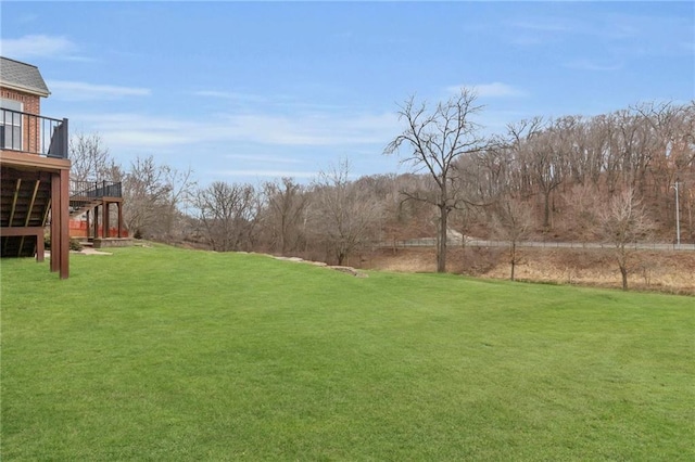 view of yard featuring stairway and a wooden deck