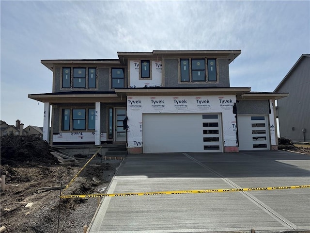 view of front of home with driveway, a porch, an attached garage, and stucco siding