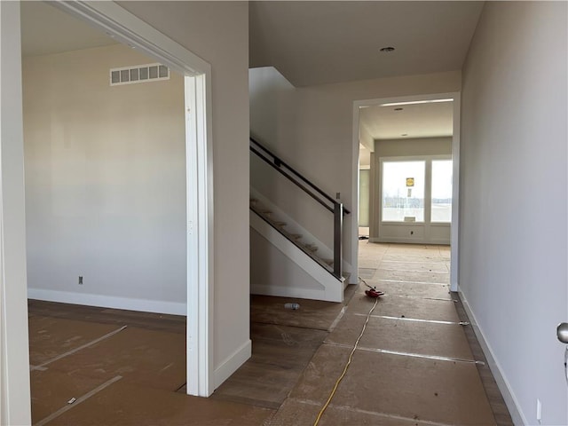 stairs featuring visible vents and baseboards