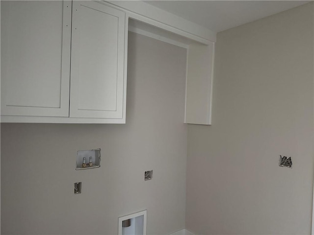 clothes washing area with cabinet space and washer hookup